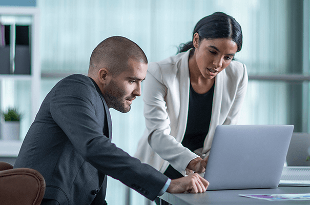 Man and woman overviewing work on laptop